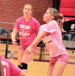 Chaye Uptmor makes a pass in the Grangeville match. Also shown is Kayla Schumacher.