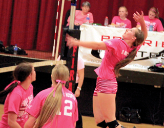 Hailey Danly goes up for a spike against Grangeville. Also shown are Natasha Gimmeson and Kayla Schumacher .