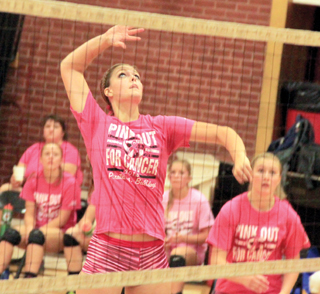 Holli Uhlorn goes for a spike against Grangeville. At right is Kayla Schumacher.