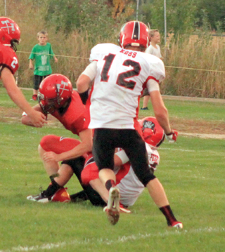 Terran Peery tackles Councils quarterback in the end zone for a safety as Tanner Ross moves in.
