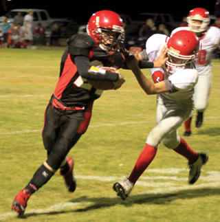 Brandon Anderson stiffarms a C.V. defender on a running play.