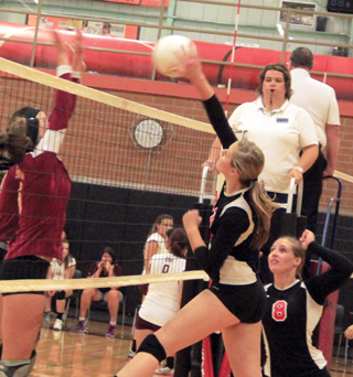 Holli Uhlorn spikes the ball against Dayton at the Border Battle.