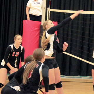 Kayla Schumacher scores on a spike against St. John-Endicott at the Border Battle. Also shown are Holli Uhlorn, Natasha Gimmeson and Hailey Danly.