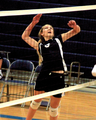 Lauren Stubbers goes up for a spike at Logos.