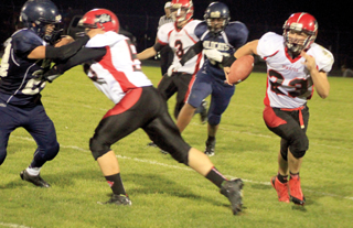 Bobby Hill, left, makes a block to spring Calvin Hinkelman for more yardage. In the background is John Mager.