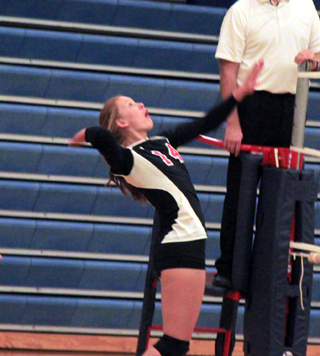 Sarah Seubert goes for a kill against Grangeville at the Genesee Tournament.