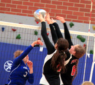 Shayla VonBargen and Hailey Danly go for a block against Colton at the Genesee Tournament.