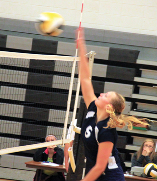 Ally Sonnen spikes the ball against Highland.