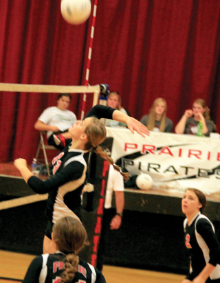 Holli Uhlorn goes for a spike against Potlatch as Krystin Uhlenkott, foreground, and Natasha Gimmeson watch.