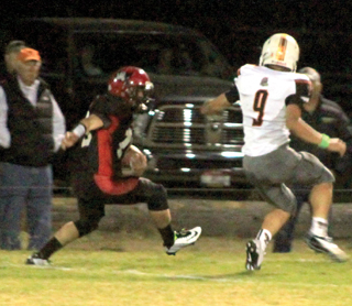 Hunter McWilliams plants his foot to make a cutback that gets him past the Troy defender shown on his 85 yard touchdown run.