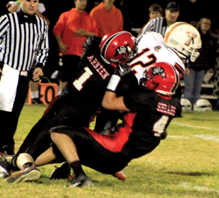 Lucas Arnzen and Isaiah Shears combine on a tackle of Troys quarterback.