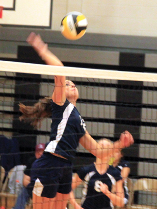 Megan Seubert goes for a kill against Highland.