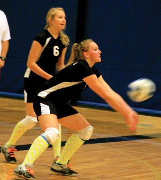 Ally Sonnen makes a pass as Ashlee Stubbers watches in Summit volleyball action at District.