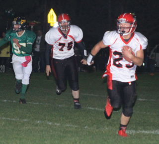 Calvin Hinkelman gains big yardage with a pass reception. Following is Philip Spencer, 75.