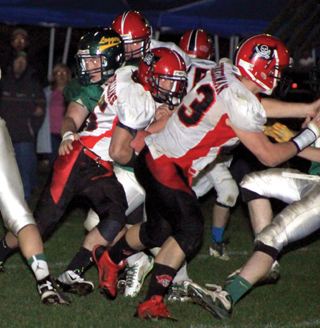Hunter McWilliams follows Calvin Hinkelman through a hole in the Potlatch defensive line and went for a huge gain.