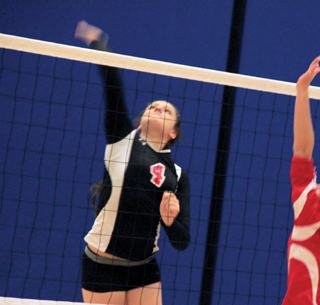 Shayla VonBargen spikes the ball against C.V.