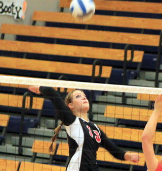 Holli Uhlorn goes for a spike against Troy.