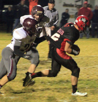 Hunter McWilliams had another big game as he tries to pull away from a shirt tail tackle attempt.