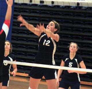 Megan Seubert pushes the ball over against Deary as Rachel Waters and Ally Sonnen watch.