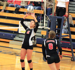 Tasha Gimmeson sets the ball as Hailey Danly gets ready to loop around behind her for a hit.
