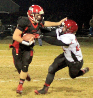 Calvin Hinkelman wards off a Wallace defender with a stiffarm as he picks up big yardage.