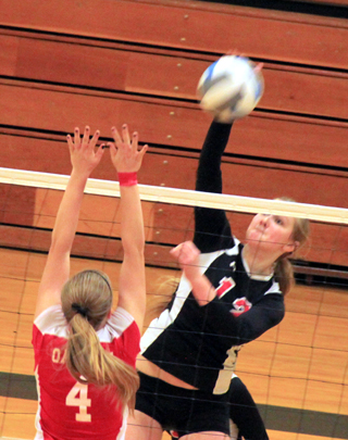 Kayla Schumacher, who led the team in kills at state, pounds one past an Oakley blocker.