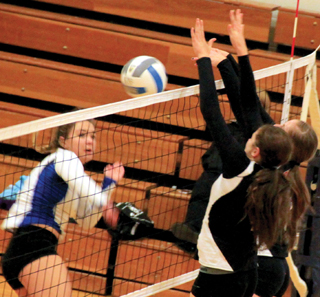 Shayla VonBargen and Hailey Danly put up a wall against a Genesee hitter in the championship match.