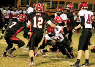 Terran Peery tackles a Wallace runner. Also shown from left are Rhett Schlader, Tanner Ross and Isaiah Shears.