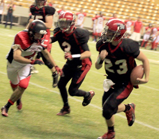 Calvin Hinkelman scored on this play. Also shown are Philip Spencer in the background and John Mager is at Hinkelmans right.