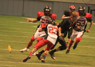 One of a long strong of personal foul penalties against Oakley in the third quarter. Here you can see Rhett Schlader without a helmet and a penalty flag at the left of the photo. Oakley was called for a facemask penalty and the play was stopped as soon as the helmet came off even though Schlader picked up about 5 more yards.