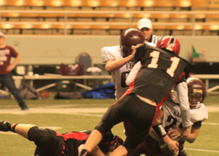 Bobby Hood, on ground holding the quarterbacks leg, and Jake Bruner, 11, combined on a sack that gave Prairie the ball back on downs in the second half.