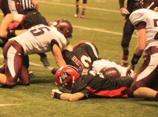 Mason Dalgliesh, 2, recovers a Kamiah fumble. John Mager, foreground, helped cause the fumble.