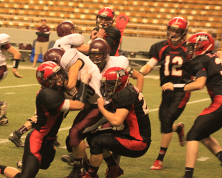 Terran Peery, left, and Calvin Hinkelman team up on a tackle. In the back ground is Lucas Arnzen with Tanner Ross, 12, and John Mager also shown.