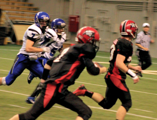 Just 14 seconds after the above touchdown, Rhett Schlader scooped up a fumble forced by Lucas Arnzen and went 22 yards for a touchdown that gave Prairie a 14-0 lead. Calvin Hinkelman is ready to block for Schlader if necessary.