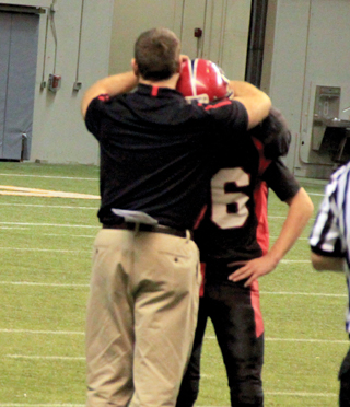 Coach Ryan Hasselstrom put in all the seniors for a play and when that play was done called a timeout and spent it hugging each senior player. Here he's hugging Dally Ratcliff.