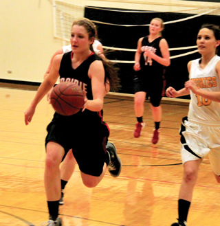 Shayla VonBargen leads the offense down the floor after another Highland turnover. Kayla Schumacher trails the play.