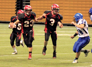 Calvin Hinkelman and John Mager lead Hunter McWilliams on a sweep around right end.