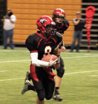 Terran Peery runs back an interception for Prairies third touchdown in a span of 1:34 late in the first quarter that broke open a scoreless game. Jake Bruner is trailing the play.