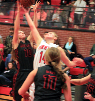Kayla Schumacher reaches for an offensive rebound against Moscow.