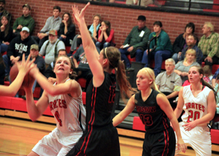 Shayla VonBargen looks to shoot in the lane against Moscow. Hailey Danly is at right.