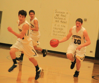 Summits Chris Osborne heads up the floor after a steal against C.V. Also shown are Tyler Krogh and Dean Stubbers.