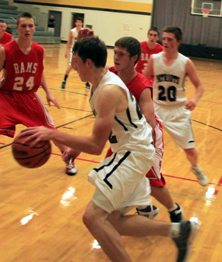 Summits Patrick Chmelik drives the baseline for what turned out to be a reverse layup. #20 is Josh Lustig.