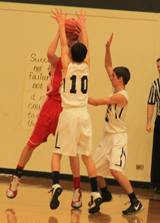 Tyler Krogh, 10, and Dean Stubbers double team the ball in Summits game against C.V.