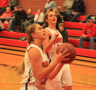 Kylie Tidwell goes for a lay-up against Kamiah. Also shown is Krystin Uhlenkott.