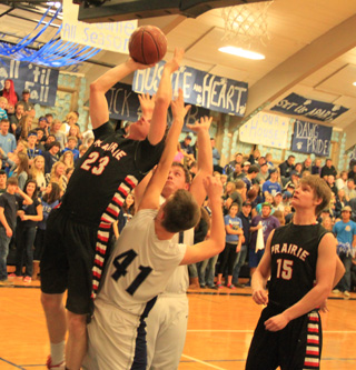 Lucas Arnzen puts up a shot and gets fouled in the Grangeville game. At right is Tanner Ross.