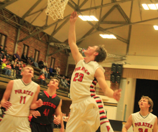 Lucas Arnzen scores on a lay-up at Moscow as Jake Bruner, left, and Calvin Hinkelman, right, look on.