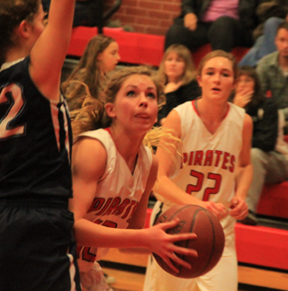 Chaye Uptmor is about to score 2 of her 7 points against Grangeville. Also shown is Krystin Uhlenkott.
