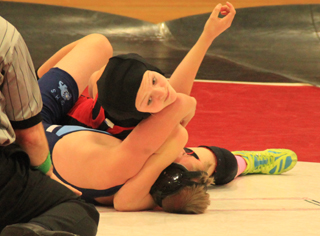 Kellie Heitman is about to pick up a pin against a Grangeville opponent.
