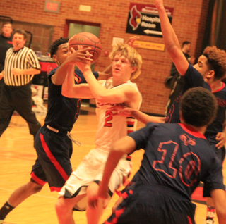 Rhett Schlader gets fouled on a drive into the lane for an attempted lay-up.