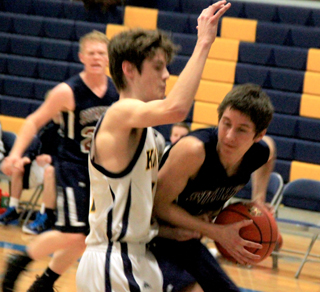 Dean Stubbers has the ball on the low block with Nathan Beckman in the background.